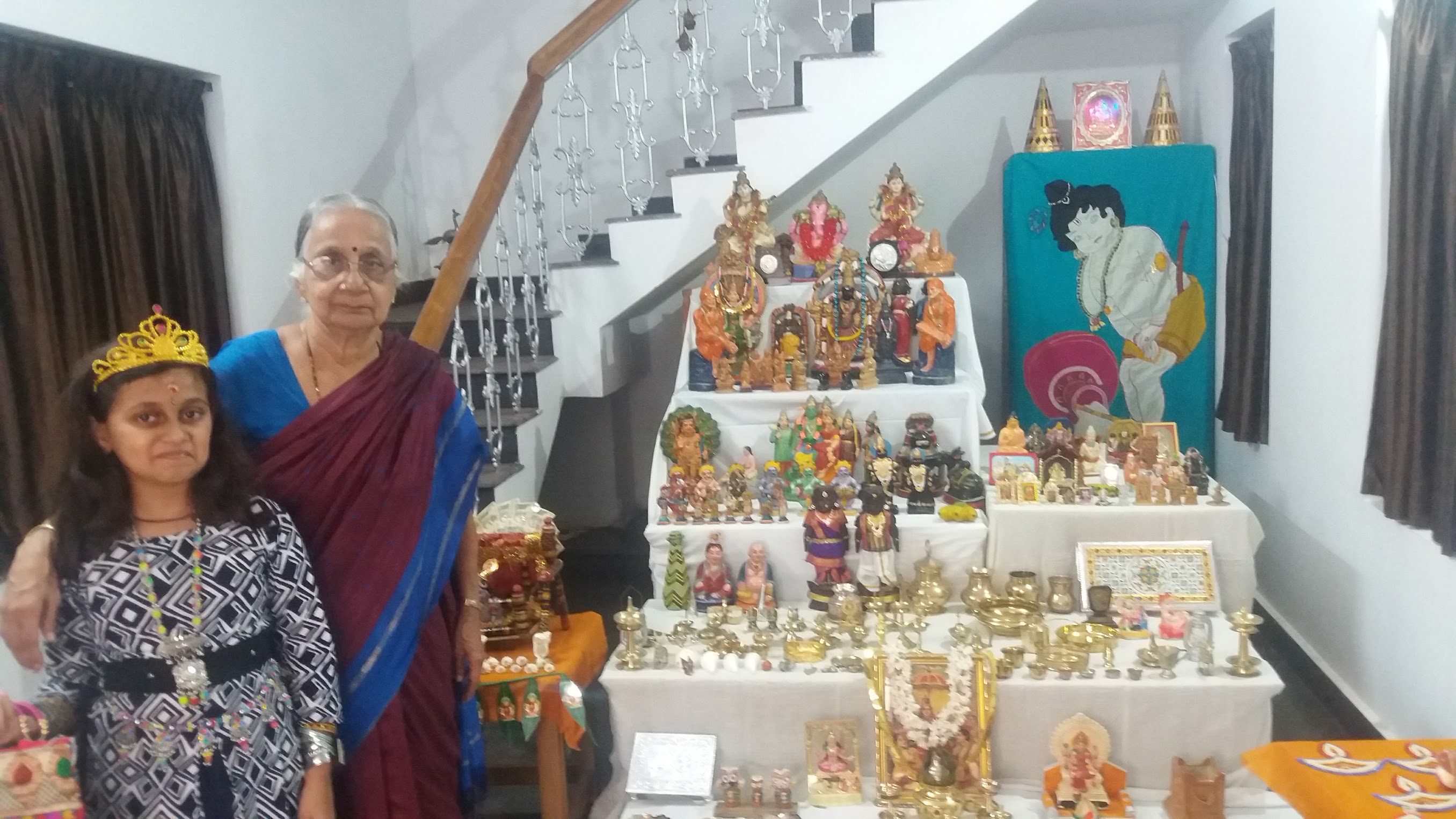 Thankam Mami with her granddaughter beside the family Golu arrangement